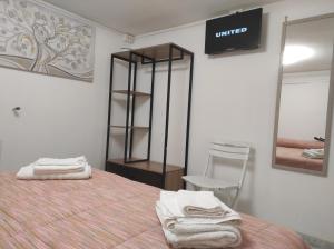 a bedroom with a bed and a mirror and a chair at Ostuni holiday nature in Ostuni