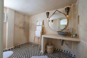 a bathroom with a sink and a mirror at Riad Dar Nor in Essaouira +69 photos