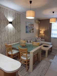 a living room with a table and a couch at Lighthouse 1bedroom GeC apartment 203 in Balchik