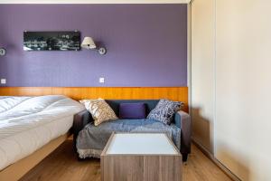 uma sala de estar com um sofá e uma mesa em GuestReady - Charming Stay near La Défense em Courbevoie