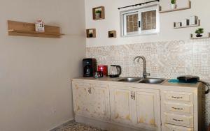 a kitchen with a sink and a counter at ARMIRA HOME in Kalymnos