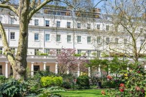 un gran edificio blanco con un jardín delante de él en Promient Royal Victorian Villa - Sleeps 12, en Londres
