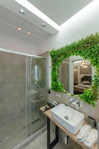 a bathroom with a sink and a shower and a mirror at Il Narciso in Rome