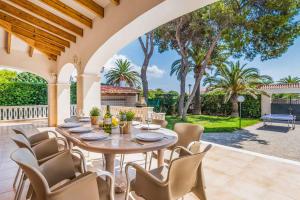 an outdoor dining room with a table and chairs at Villa Jalima in Son Carrio