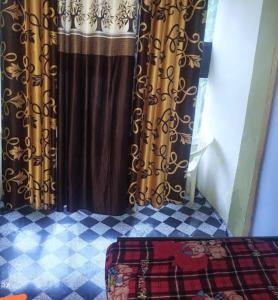 a shower curtain in a room with a checkered floor at Shivdoot hotal in Bhind