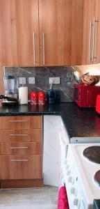 a kitchen with a stove and a counter top at It's Hove Actually.... in Brighton & Hove