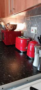 two red toasters sitting on top of a kitchen counter at It's Hove Actually.... in Brighton & Hove