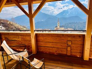 two chairs on a porch with a view of mountains at Casa Felice in Trin