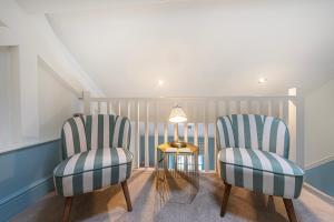 two chairs and a table in a room at Escape Boutique B&B in Llandudno