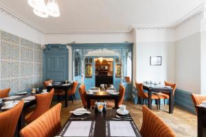 a dining room with tables and chairs at Escape Boutique B&B in Llandudno