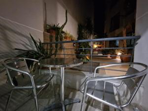 una mesa y sillas en una habitación con plantas en MIVE -Bugibba Modern Apartment next to main square, en St Paul's Bay