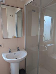 a bathroom with a sink and a shower at Hidden Gem Wilksworth Caravan Park Rural and Peaceful Setting in Wimborne Minster
