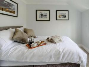 a white bed with a tray of food on it at Stunning 2-Bed House in Walkington near Beverley in Beverley