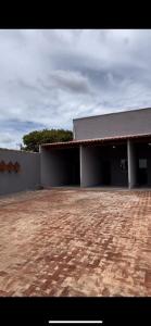a large building with a brick ground in front of it at Apartamento Loft in Rio Verde