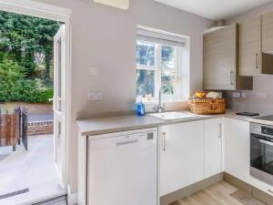 una cocina con armarios blancos y una ventana en Stunning 2-Bed House in Walkington near Beverley, en Beverley