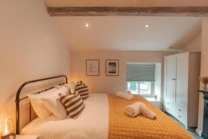 a bedroom with a large bed with pillows at Bridge Apartment in Stockport