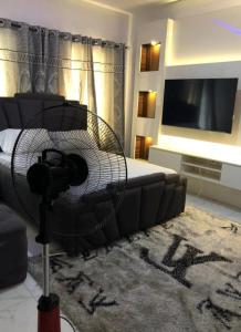 a living room with a couch and a flat screen tv at Beautiful 3-Bed House in Lekki in Ikota