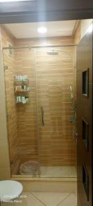 a shower with a glass door in a bathroom at Luxury Appartement, en plein centre in Kenitra