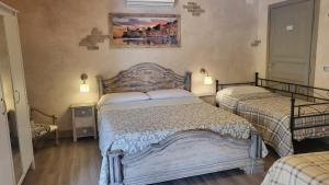 a bedroom with two beds and a painting on the wall at B&b Il Rustico in Sestri Levante