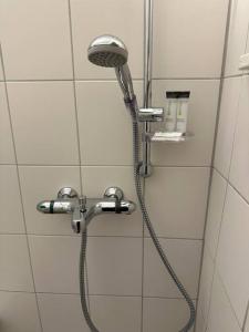 a shower with a shower head in a bathroom at City Apartment am Ku'damm & ICC Messe/Free Parking in Berlin