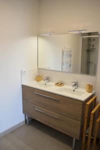 a bathroom with a sink and a mirror at Entre Plage et Ports, Le 49 - avec balcon 4 étoiles in Courseulles-sur-Mer +21 photos