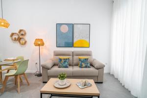 a living room with a couch and a table at Apartamentos Alnatur in Córdoba