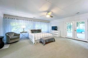 a bedroom with a bed and a chair and a window at Happy Camper Haven in Alpharetta