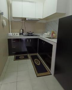 a small kitchen with a stove and a sink at Cozy Nest at Coutryhomes Rawang by Bliss Stay Management in Rawang