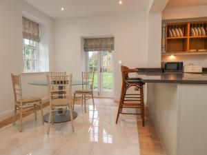 a kitchen and dining room with a table and chairs at The Lodge House in Lancaster