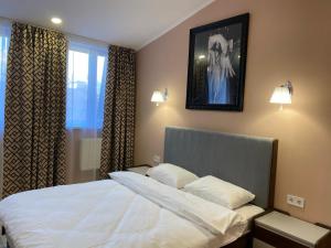 Postel nebo postele na pokoji v ubytování Kyiv Central Apart Hotel