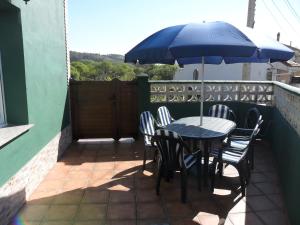 a table and chairs with an umbrella on a patio at Casa Pepe El Segador - VV-1054-AS in San Juan de la Arena