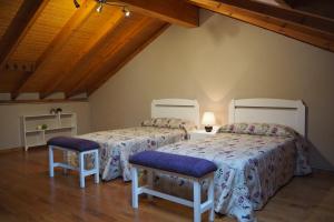 two beds in a room with wooden ceilings at Casa Pepe El Segador - VV-1054-AS in San Juan de la Arena
