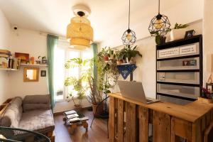 a living room with a laptop on a wooden table at Green Hostel Oviedo in Oviedo