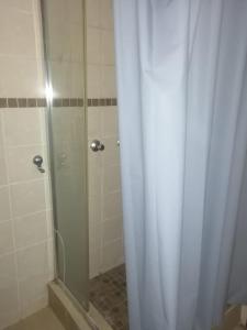 a shower with a shower curtain in a bathroom at GLORIA'S GUESTS.COM in Polokwane