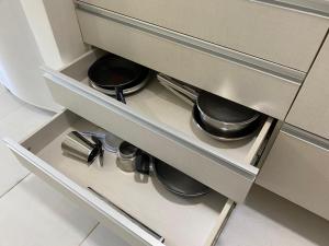 a drawer with pots and pans in a kitchen at FUSION in Brasilia