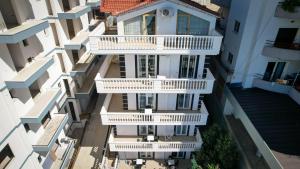 an overhead view of a white building with balconies at Villa Xika in Sarandë