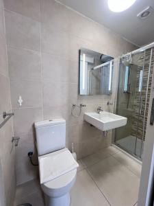 a bathroom with a toilet and a sink at Sunshine Court Apartment No 1 in Sliema