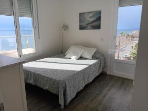 um quarto com uma cama e vista para o oceano em Alojamiento Iberia Playa em Estepona