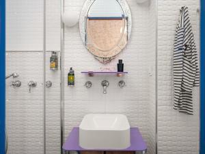 a bathroom with a sink and a mirror on the wall at Hôtel Crayon Rouge in Paris +37 photos