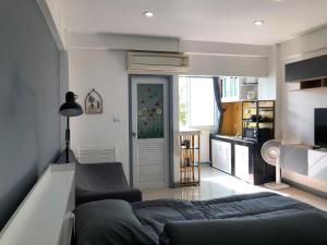 a living room with a bed and a kitchen at Cozy Patong studio apartment in Patong Beach