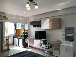 a living room with a bed and a desk at Cozy Patong studio apartment in Patong Beach