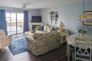 a living room with a couch and a table at Bethany Bay Condos in Ocean View