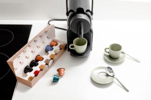 a coffee maker and a box of cupcakes on a table at Venice Suite San Marco 213 in Venice