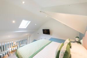 a bedroom with a bed and a skylight at Escape Boutique B&B in Llandudno