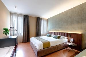 a hotel room with a bed and a television at Venice Suite San Marco 213 in Venice +12 photos