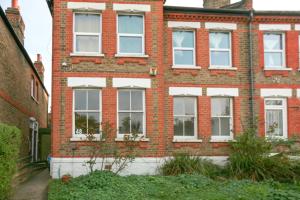 a red brick building with white windows on it at 2 Bed Apartment in Sydenham, London in Forest Hill