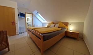 a bedroom with a bed with a nightstand and a window at Weingut u. Gästehaus Becker in Platten