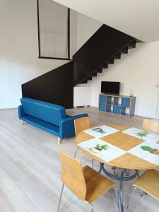 a living room with a table and a blue couch at Le Residenze di Mantova in Mantova