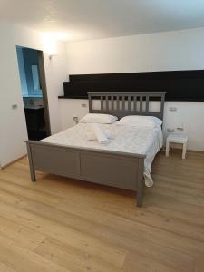 a bedroom with a large bed with a wooden floor at Le Residenze di Mantova in Mantova