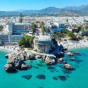 an aerial view of a beach with tourists and buildings at Abril Nerja in Nerja